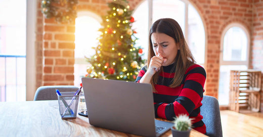 Woman in holiday setting, sneezing