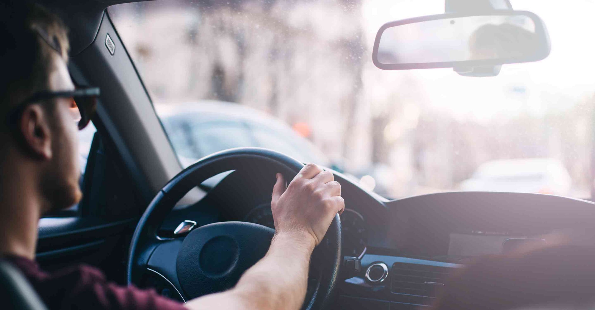 Man steers car on street