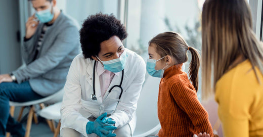 Doctor tending to child in waiting room