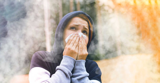 woman covering her face in smoke