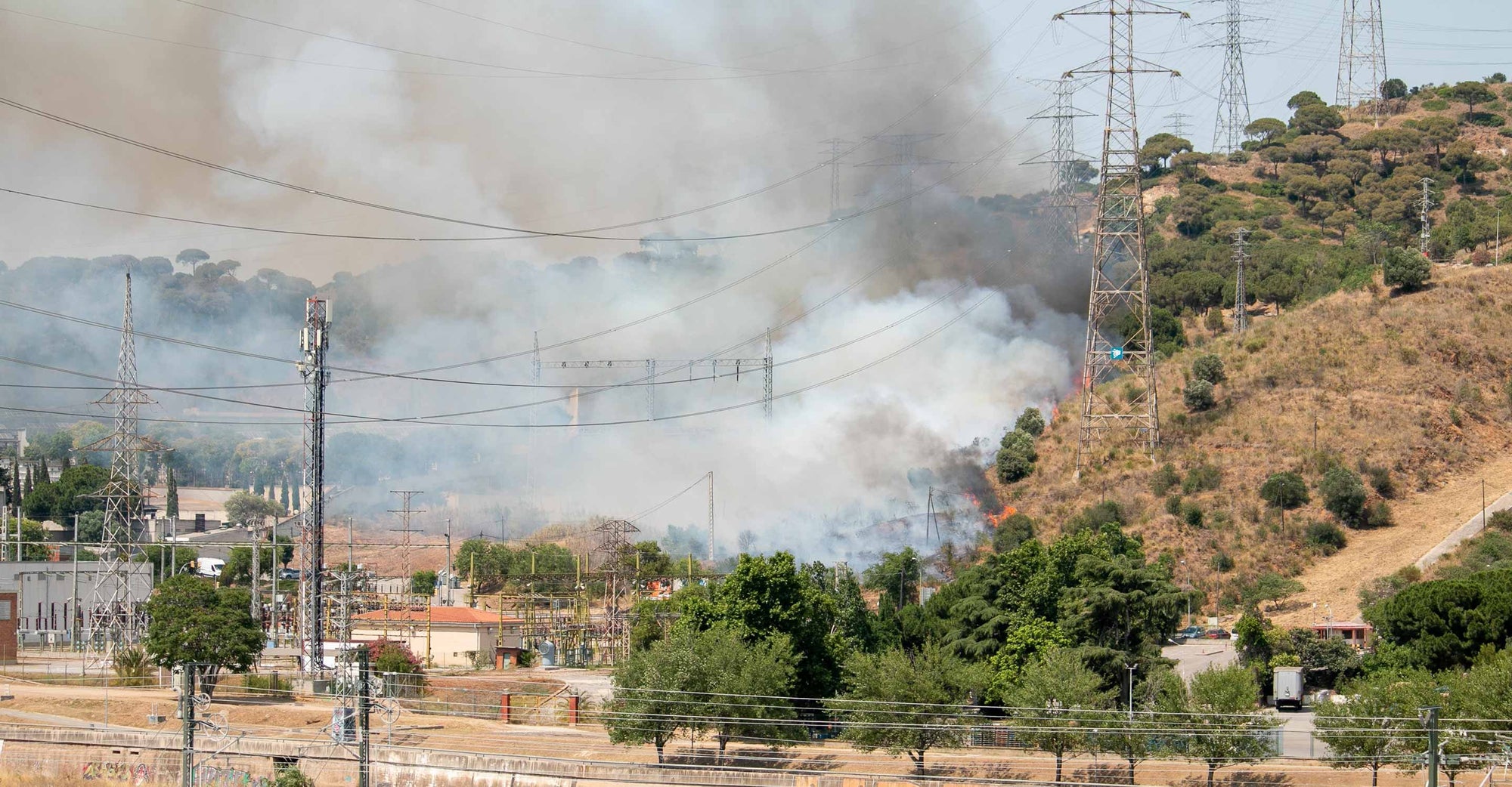 Smoke rising over homes and powerlines
